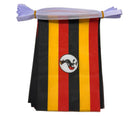 Uganda flag bunting with black, yellow, and red stripes featuring a circular emblem