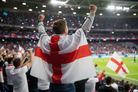 Person with England flag draped over shoulders at sports event