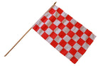 Red and white checkered flag on a wooden stick